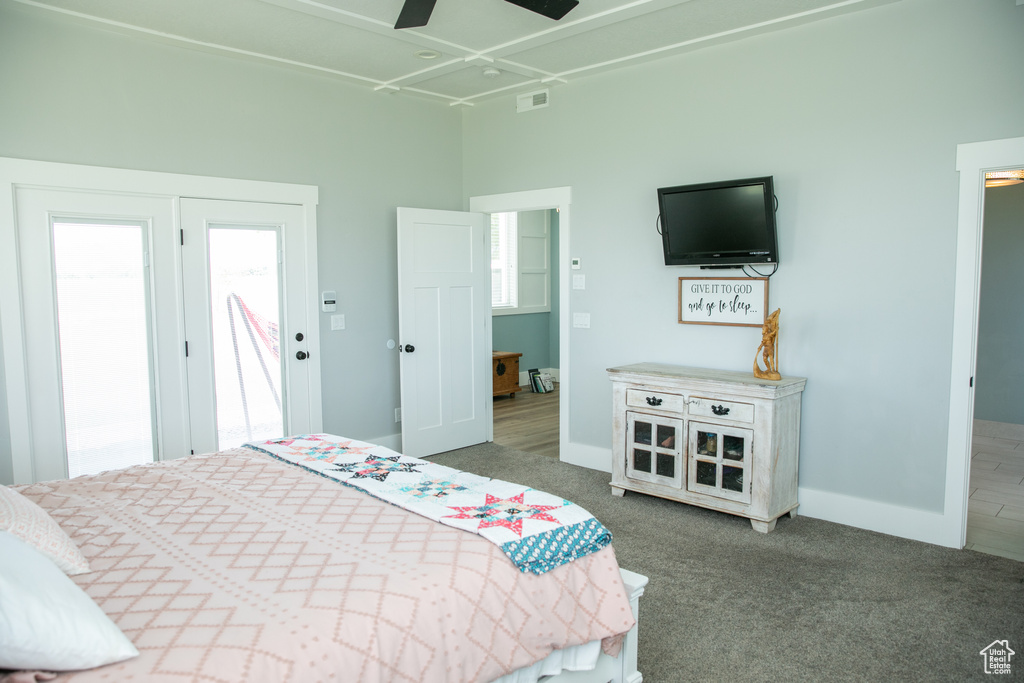 Bedroom with dark hardwood / wood-style floors, a high ceiling, and ceiling fan