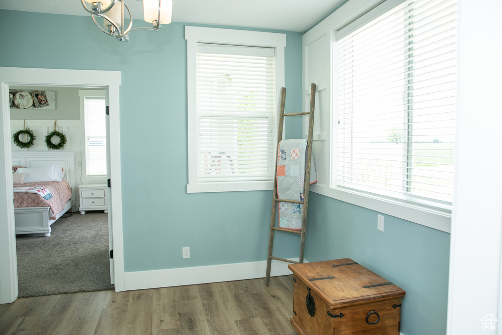 Bedroom with wood-type flooring and a chandelier