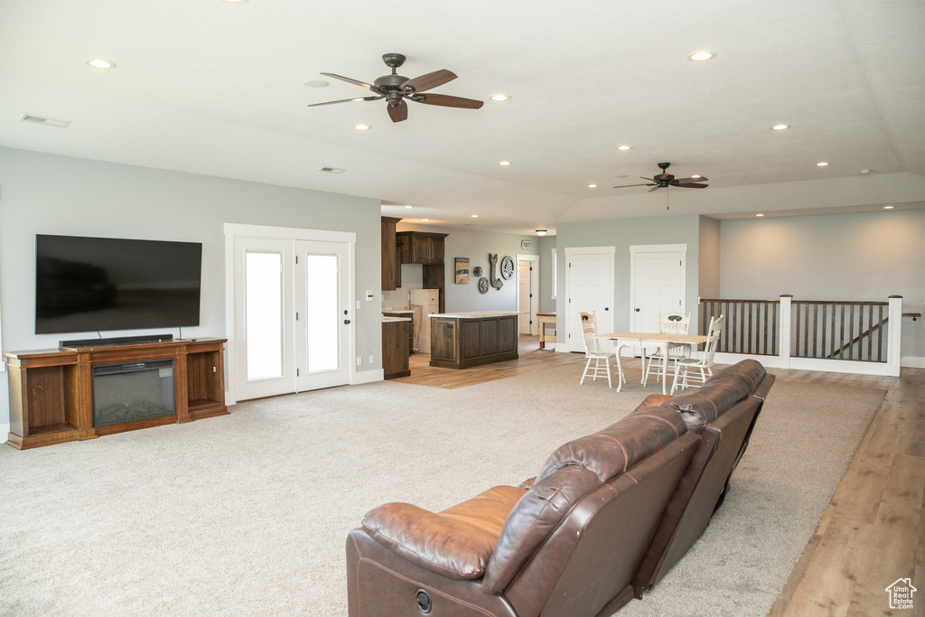 Living room with light wood-type flooring and ceiling fan