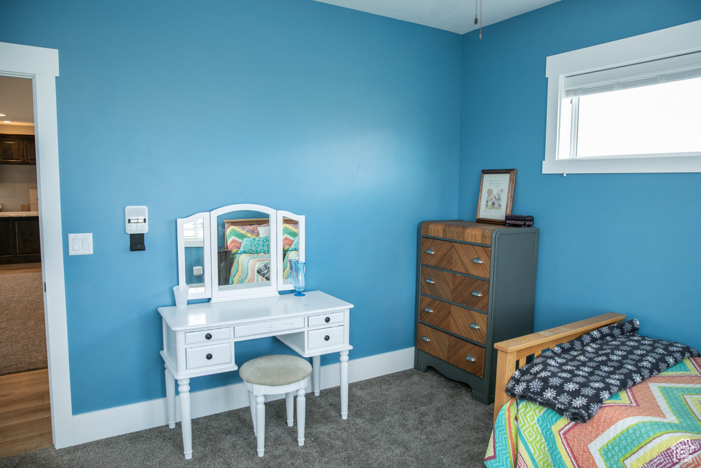 Bedroom with dark hardwood / wood-style flooring