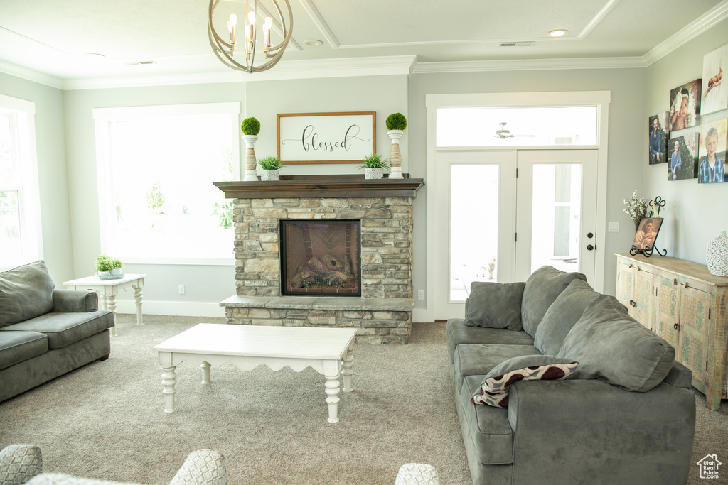 Living room featuring a fireplace, a healthy amount of sunlight, and carpet floors