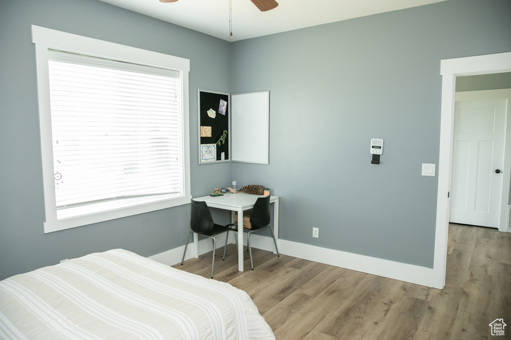 Bedroom featuring ceiling fan and hardwood / wood-style flooring