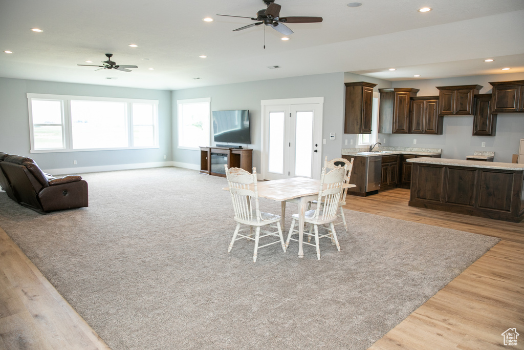 Dining space featuring light hardwood / wood-style floors, sink, and ceiling fan