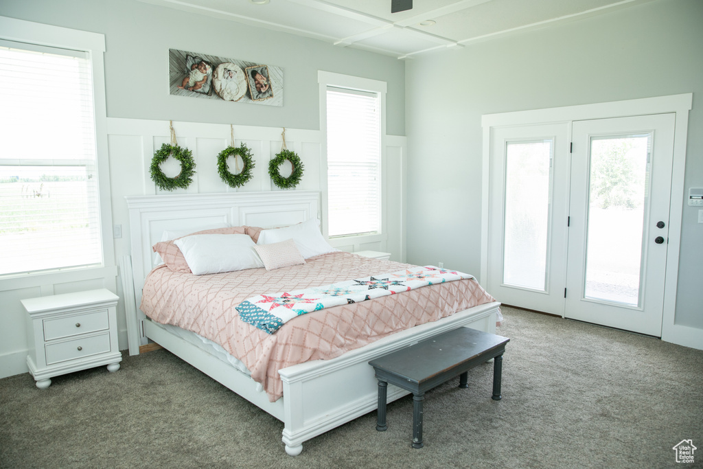 Carpeted bedroom featuring access to outside