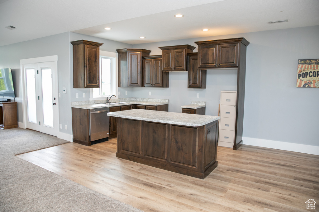 Kitchen featuring light hardwood / wood-style flooring, a center island, dishwasher, dark brown cabinetry, and sink