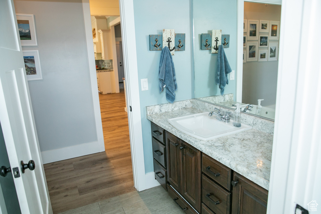 Bathroom featuring vanity and wood-type flooring