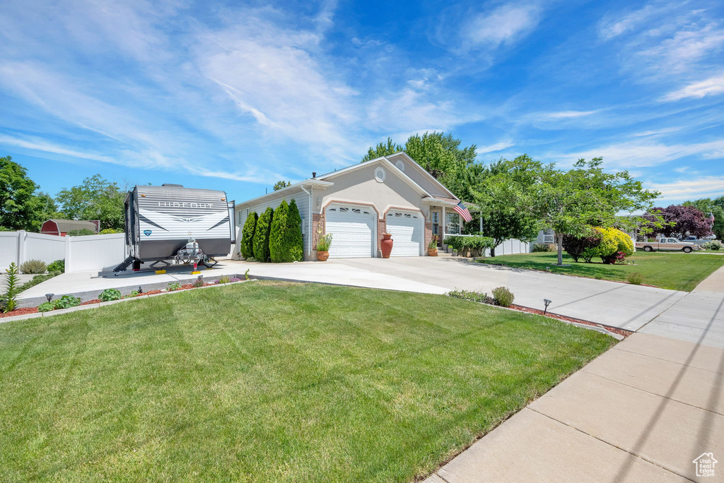 View of front of home featuring a garage and a front lawn