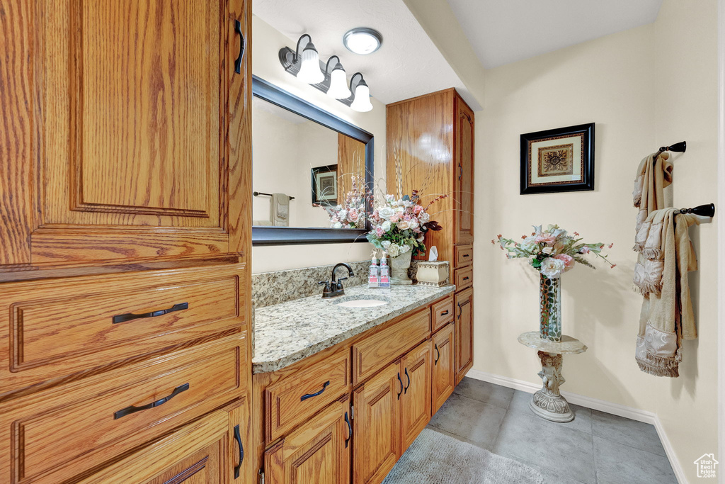 Bathroom featuring tile patterned flooring and vanity