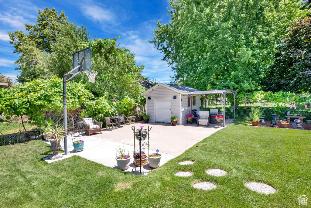 View of yard featuring a patio and an outdoor structure