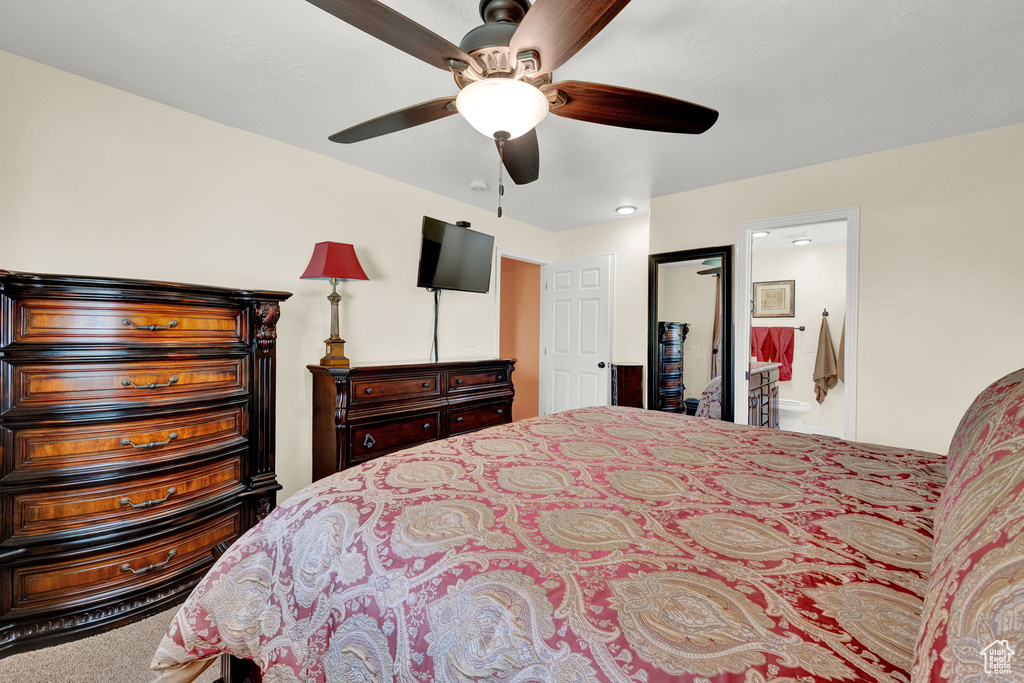 Bedroom with carpet, ensuite bath, and ceiling fan