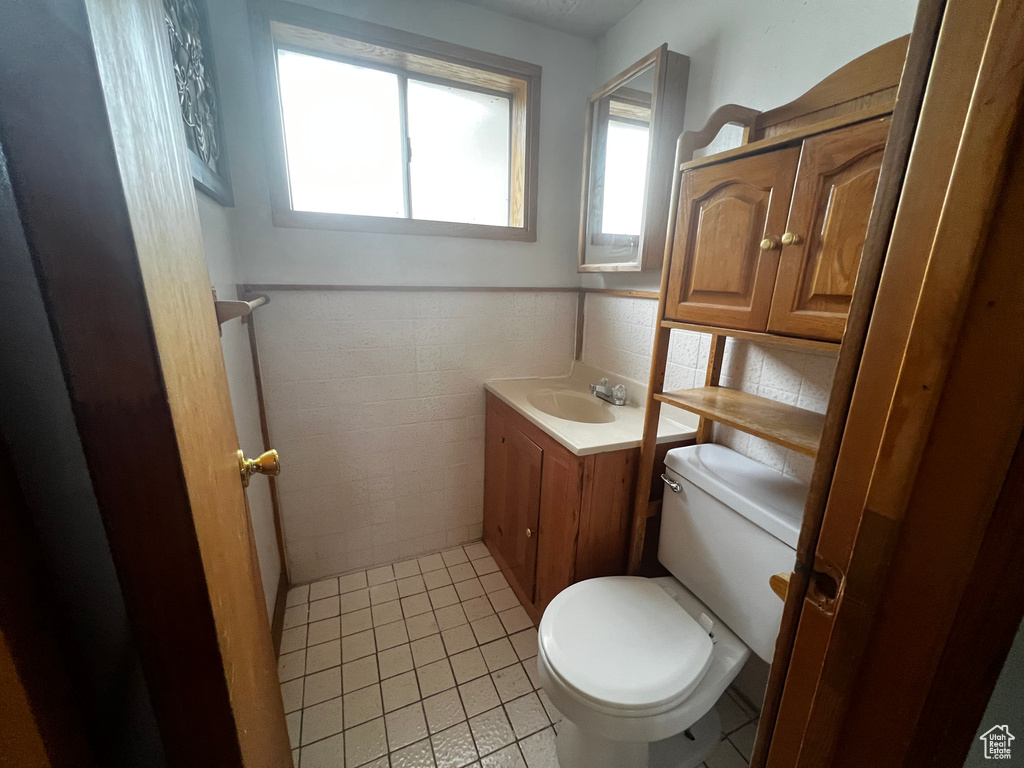 Bathroom featuring tile patterned floors, vanity, and toilet