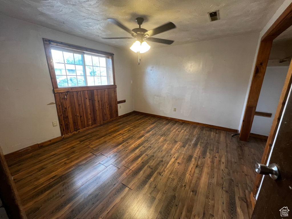 Unfurnished bedroom with wood-type flooring and ceiling fan