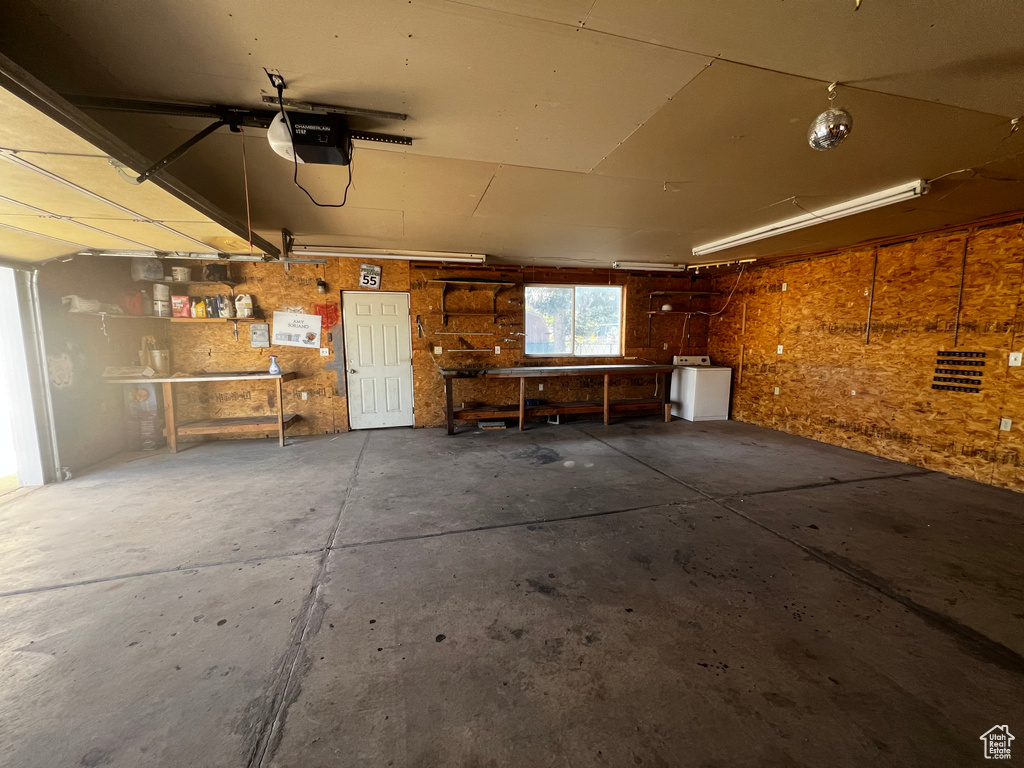 Garage featuring washer / clothes dryer and a garage door opener