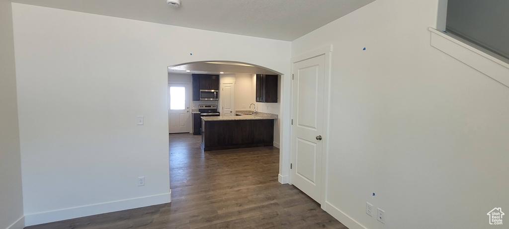 Corridor featuring sink and dark hardwood / wood-style floors