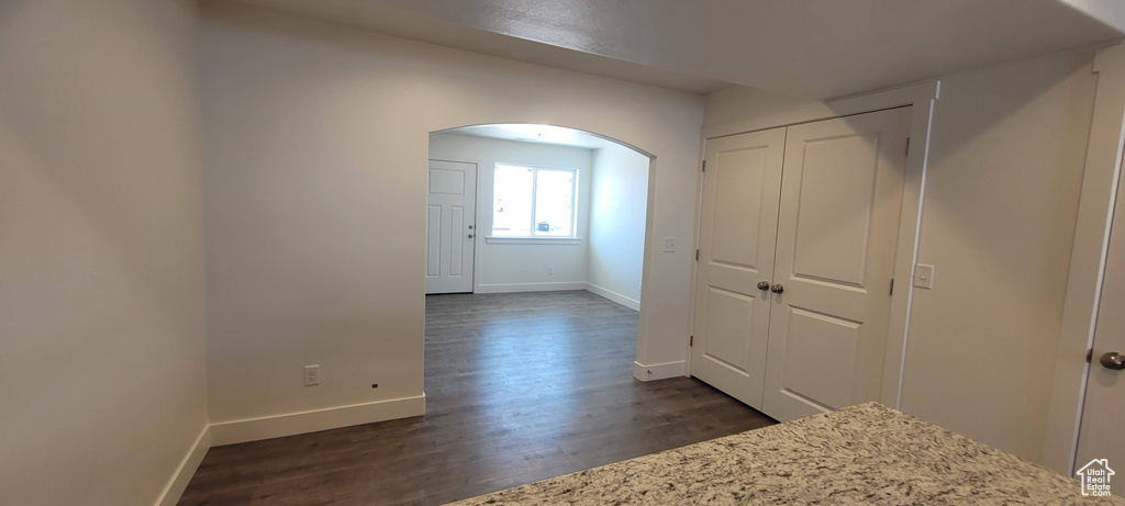 Hallway with dark hardwood / wood-style floors