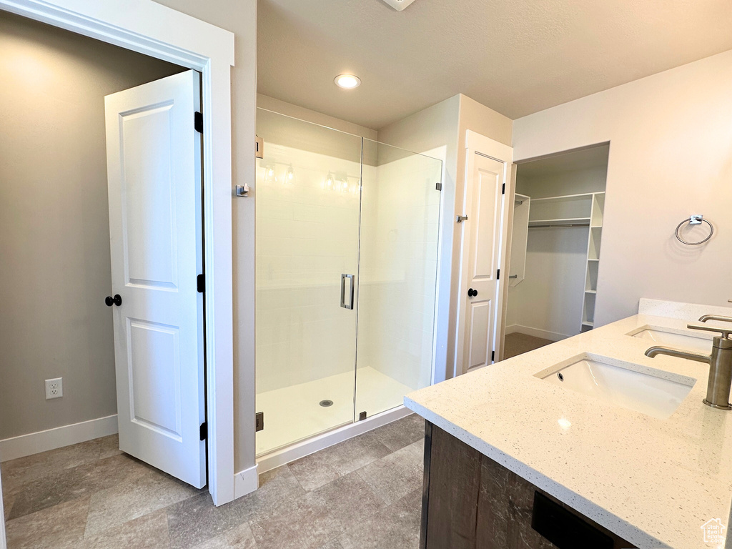 Bathroom with vanity and a shower with door