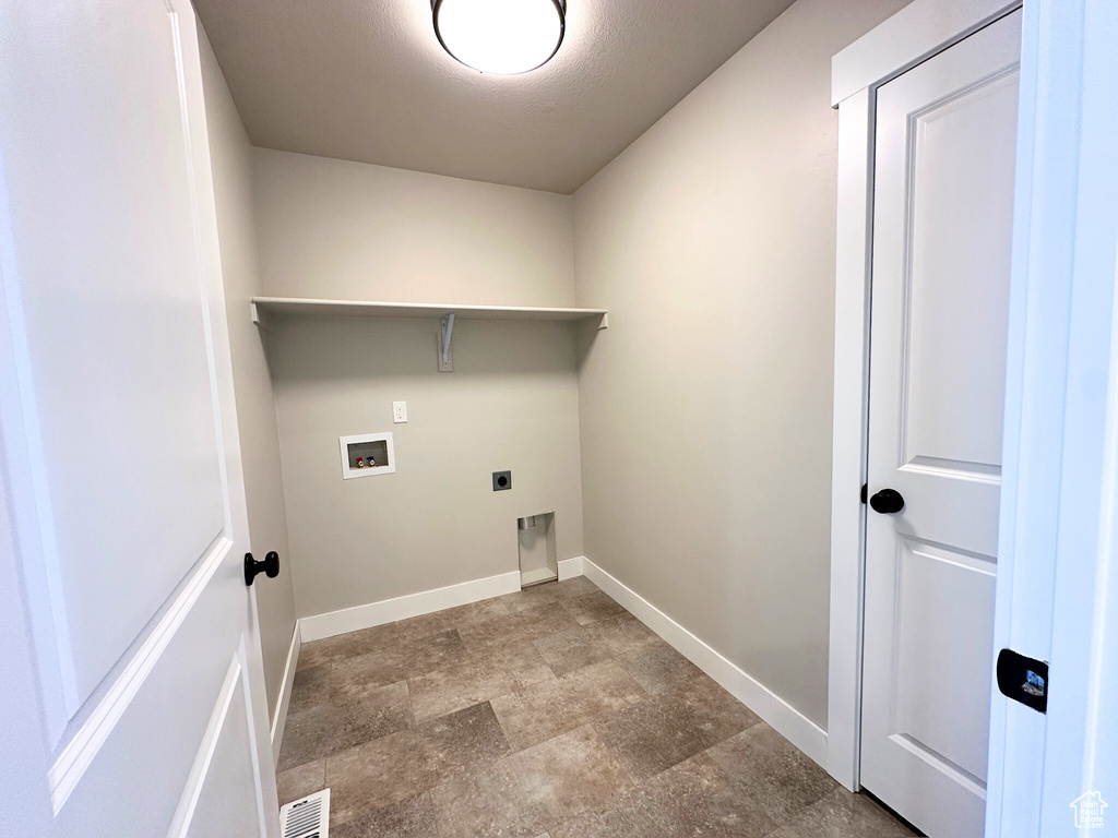 Washroom featuring a textured ceiling, electric dryer hookup, and washer hookup