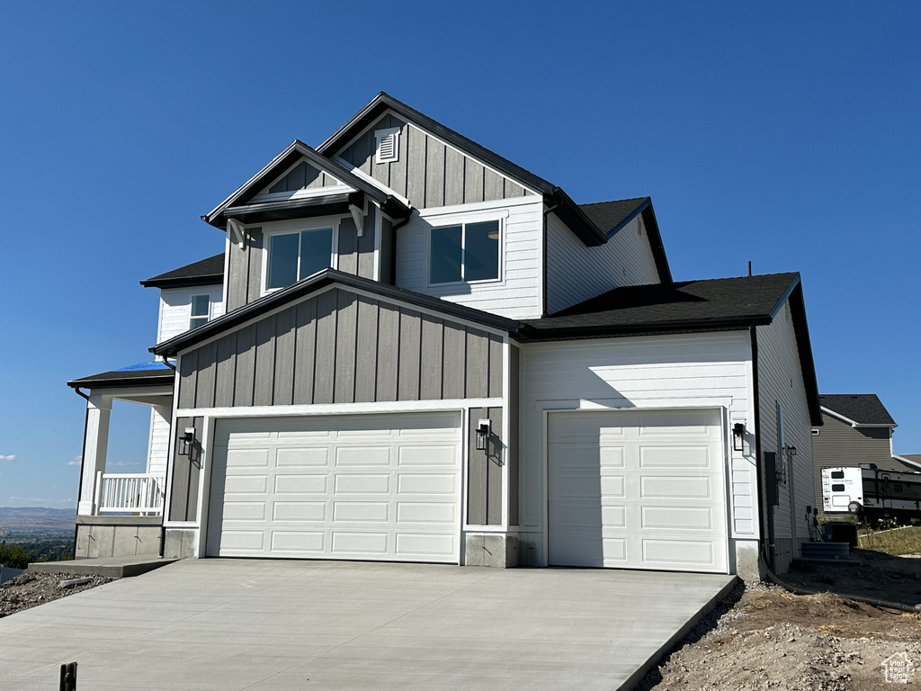 View of front of home featuring a porch and a garage