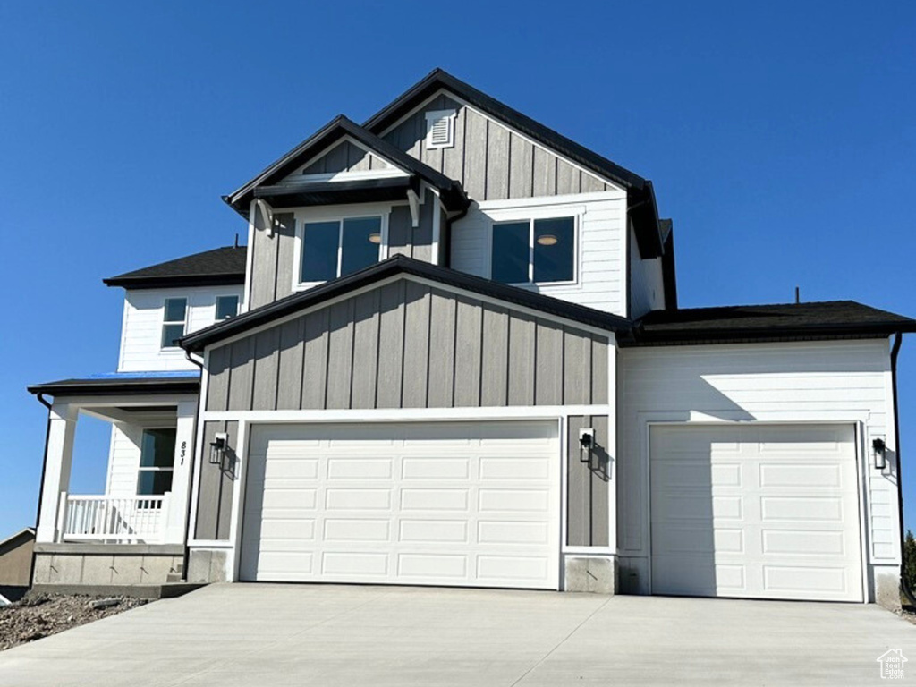 View of front of property with a garage and covered porch