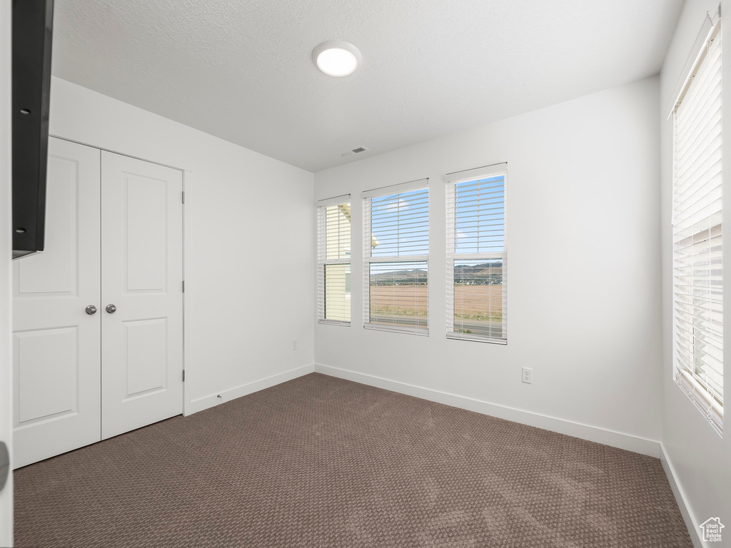 Unfurnished bedroom with a closet and carpet