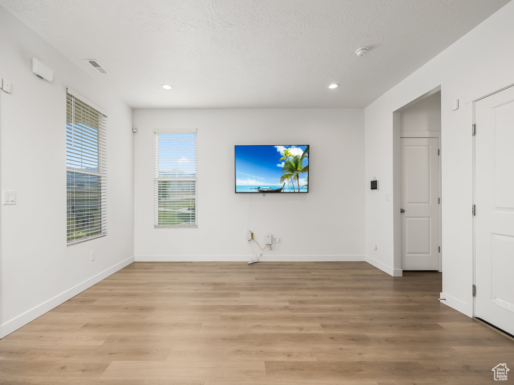 Empty room featuring wood-type flooring