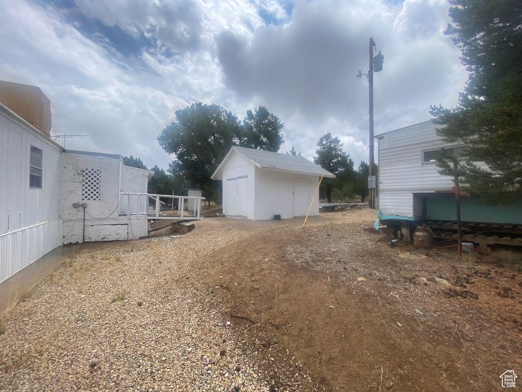 View of yard with a storage unit