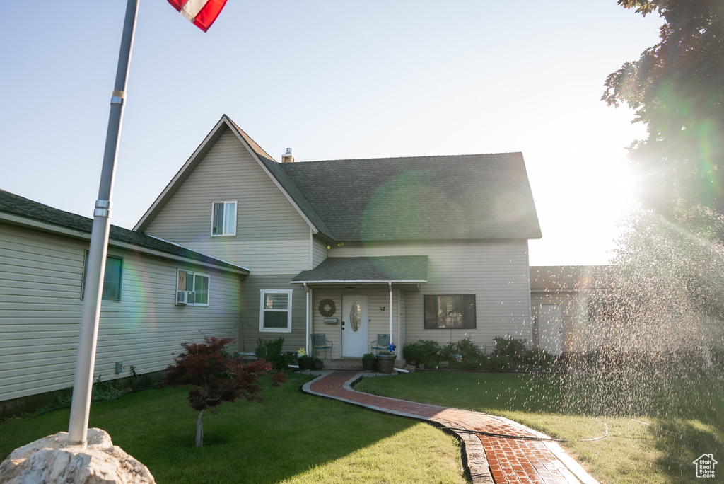 Rear view of property featuring a lawn