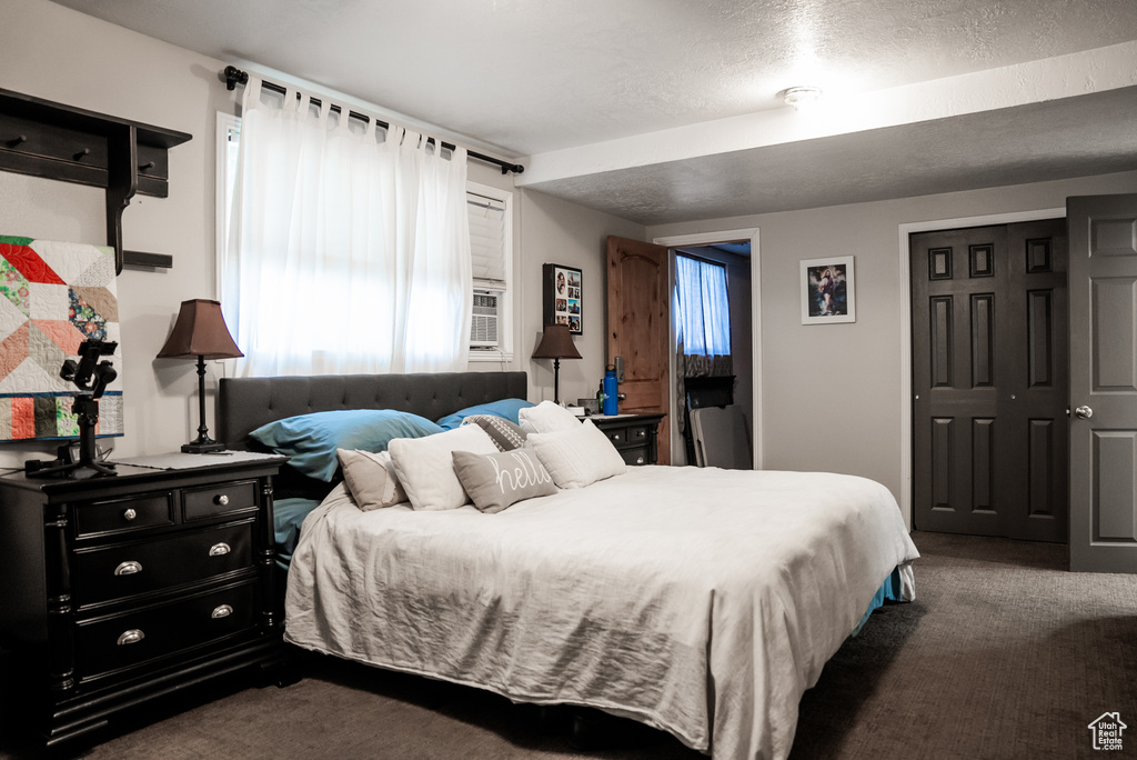 Carpeted bedroom featuring a textured ceiling