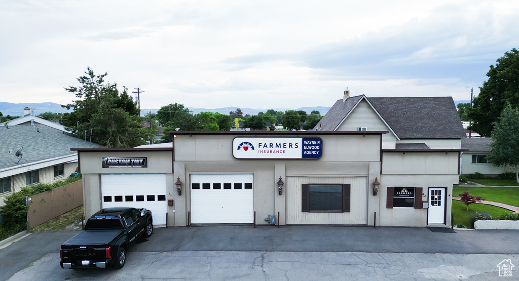 View of front of home featuring a garage and a mountain view