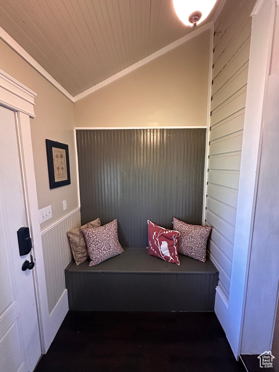 Living area with crown molding and lofted ceiling