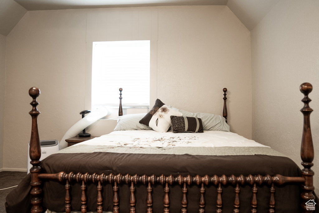 Carpeted bedroom with vaulted ceiling