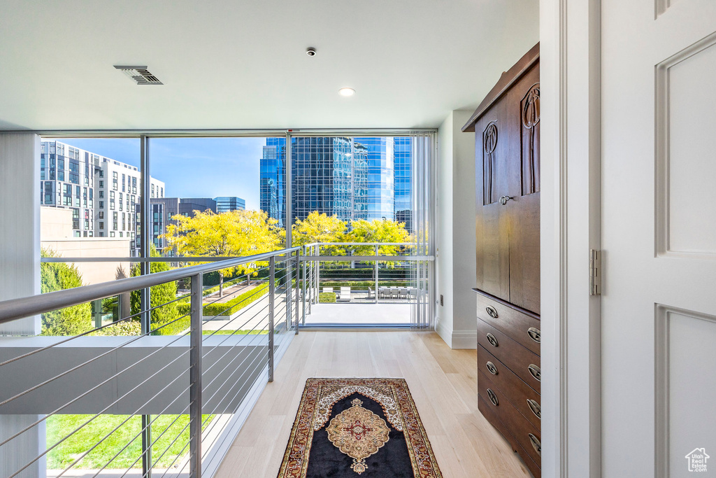 Interior space with light hardwood / wood-style flooring, multiple windows, and expansive windows