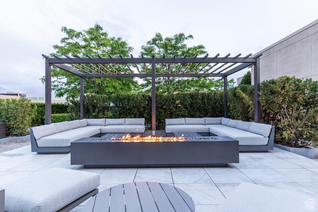 View of patio / terrace featuring an outdoor living space with a fire pit and a pergola