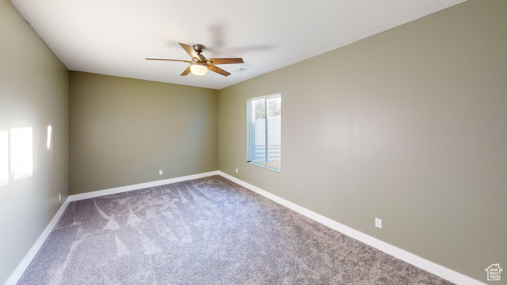 Unfurnished room featuring carpet flooring and ceiling fan