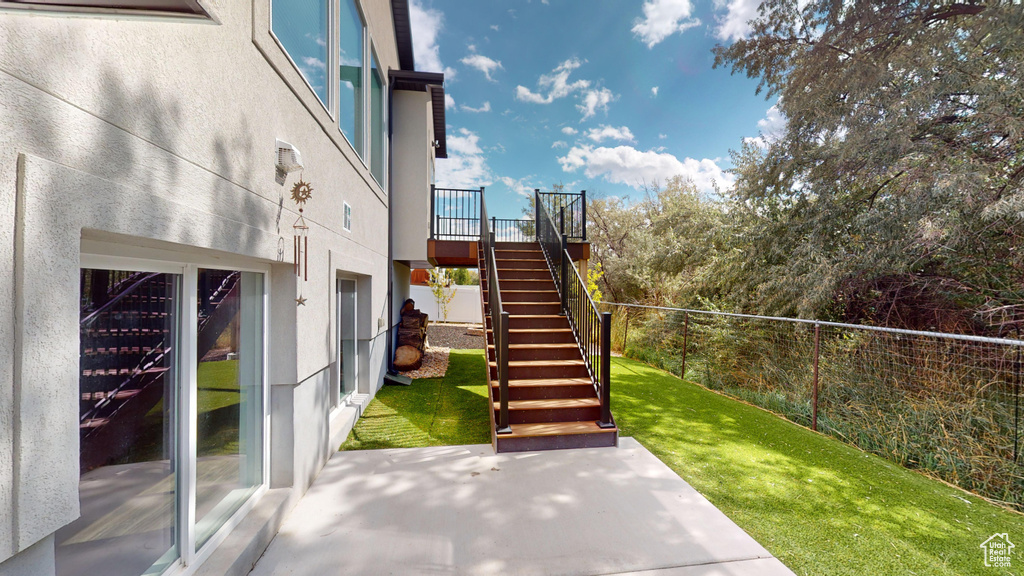 Exterior space with a patio area and a yard