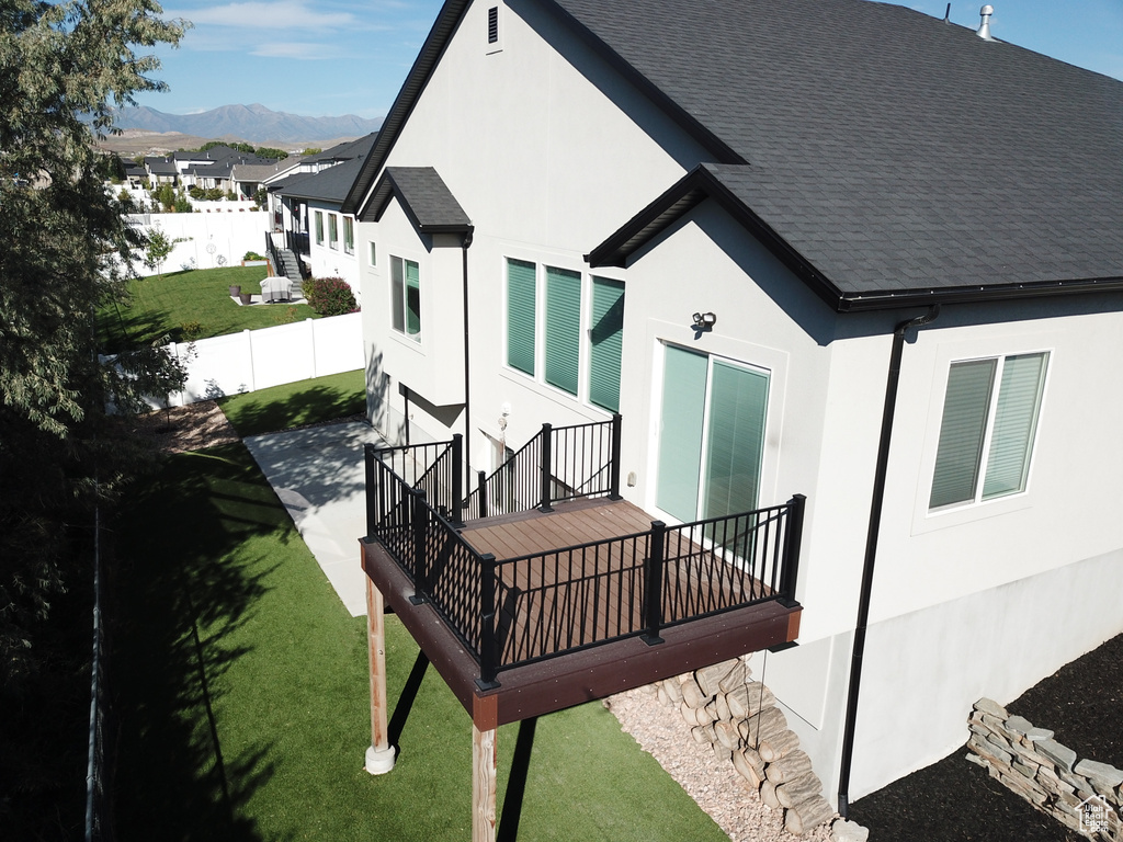 Rear view of property featuring a yard and a mountain view