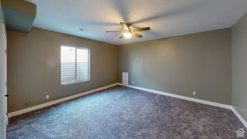 Empty room with carpet floors and ceiling fan