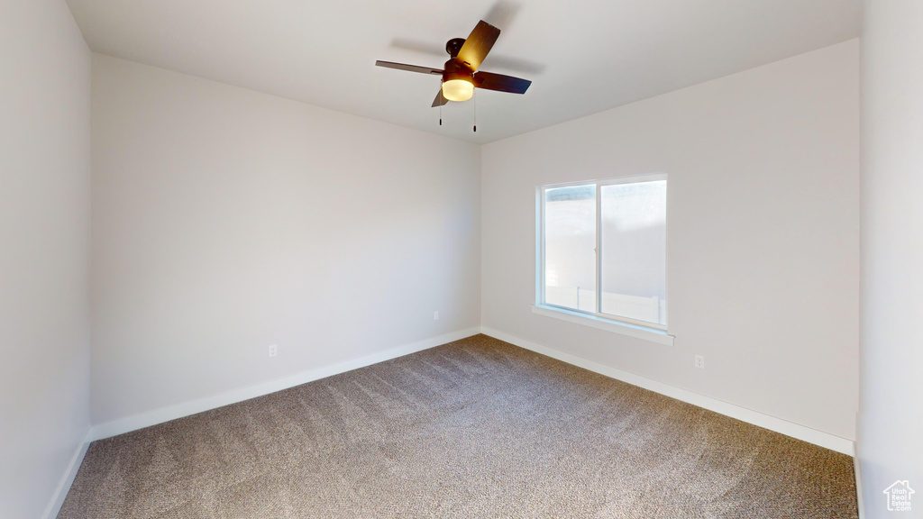 Unfurnished room featuring carpet flooring and ceiling fan