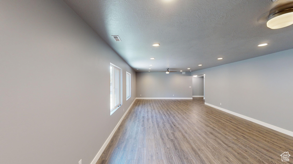 Spare room with a textured ceiling and hardwood / wood-style floors