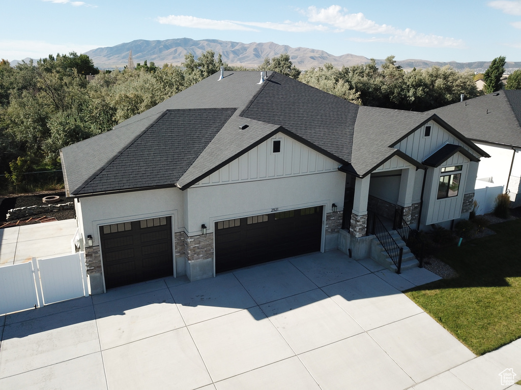 View of front facade featuring a garage and a mountain view