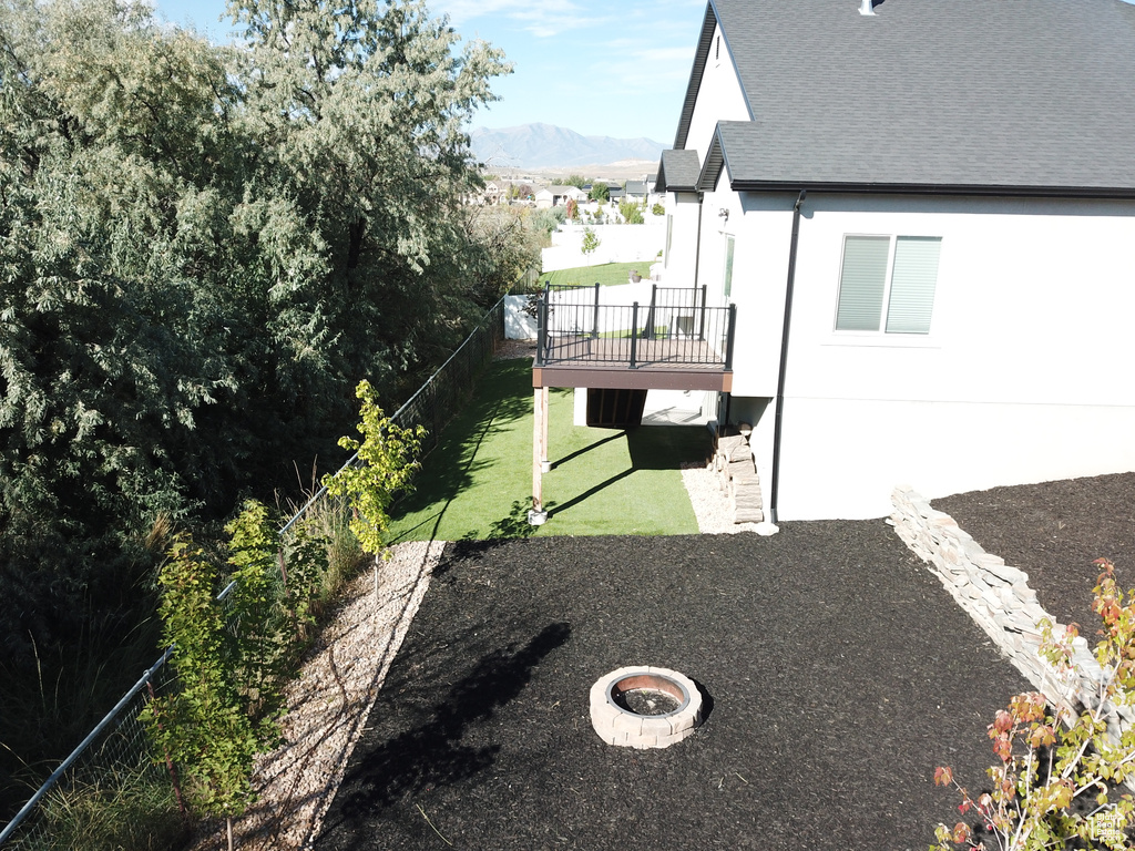 View of yard featuring a deck with mountain view