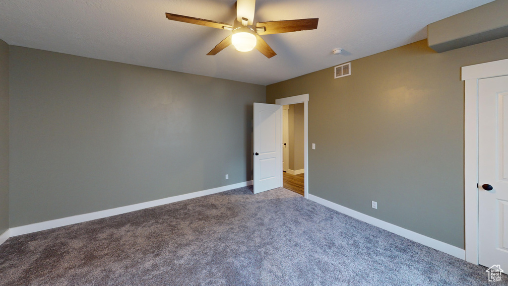 Unfurnished bedroom with ceiling fan and carpet floors