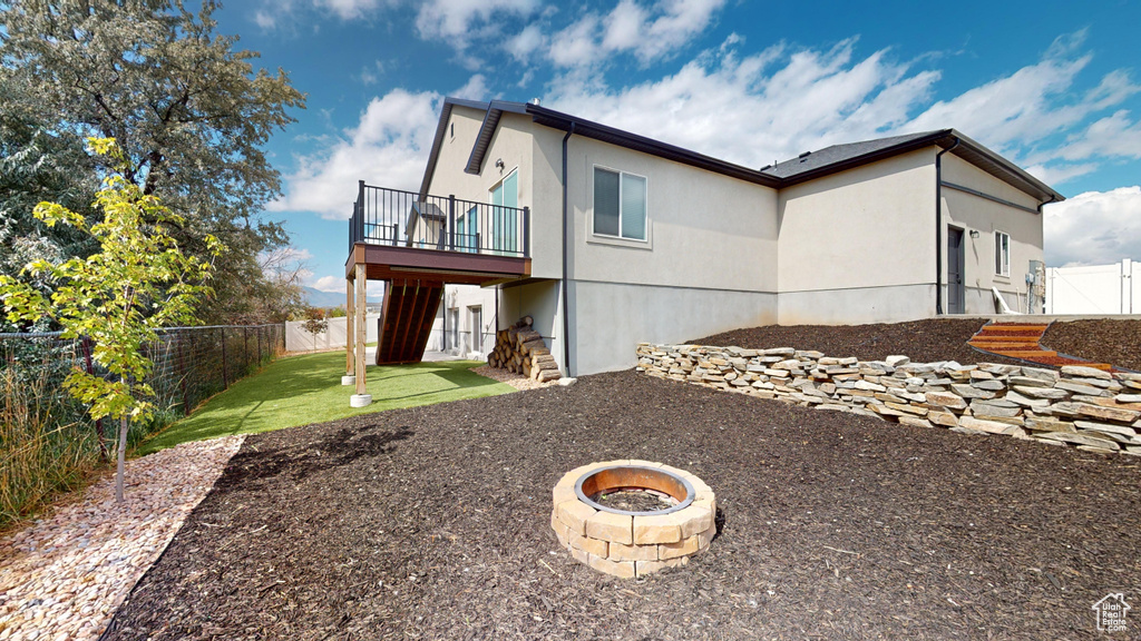 Rear view of house featuring a fire pit