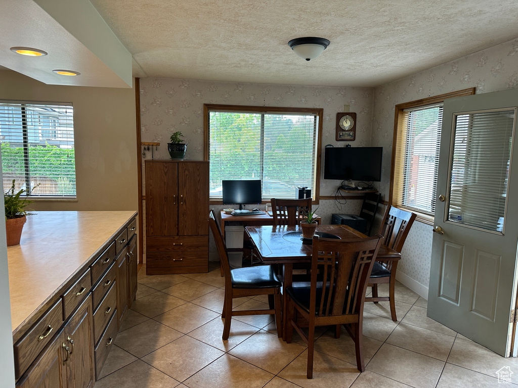 Tiled dining space with a textured ceiling