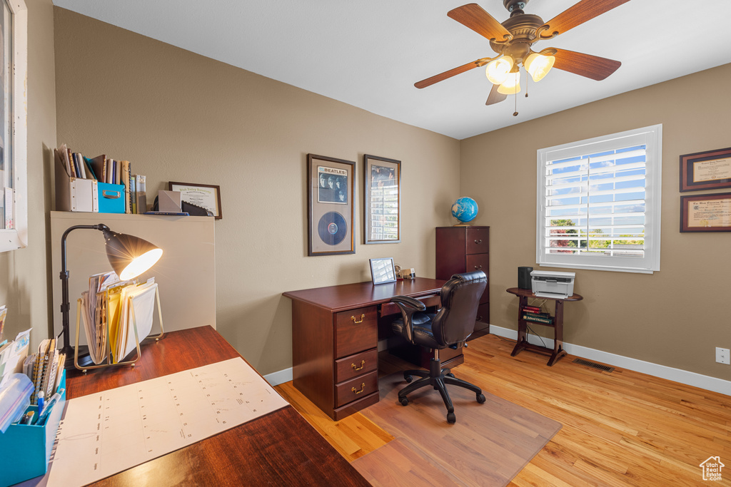 Office area featuring wood-type flooring and ceiling fan