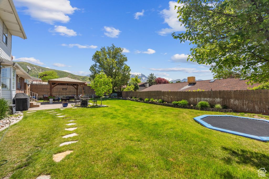 View of yard featuring a patio and a gazebo