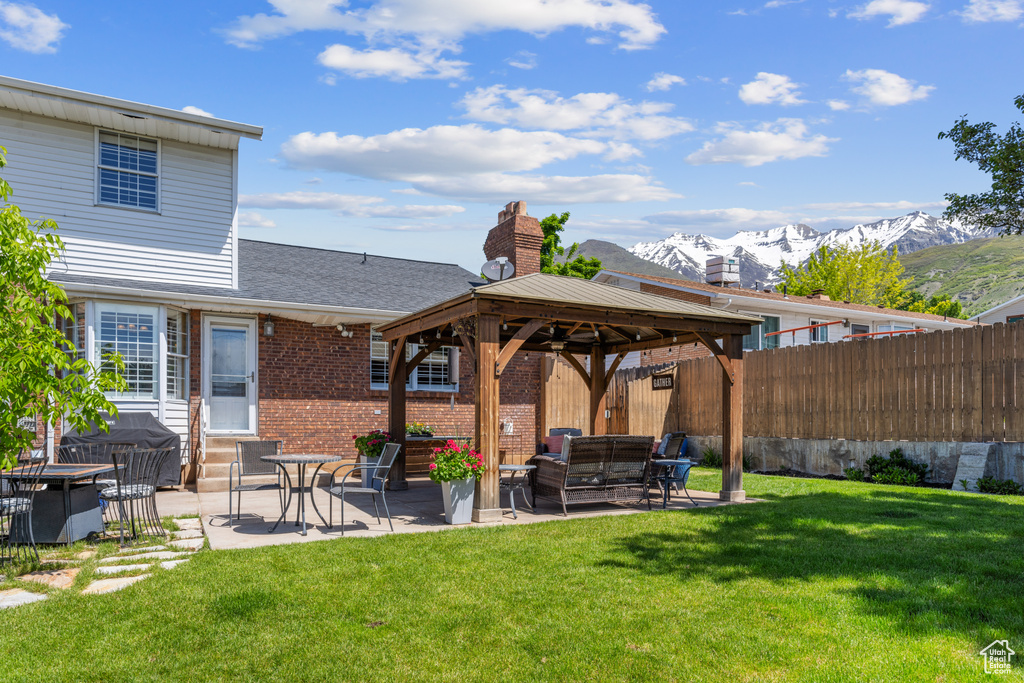 Exterior space featuring a patio, a mountain view, and a gazebo