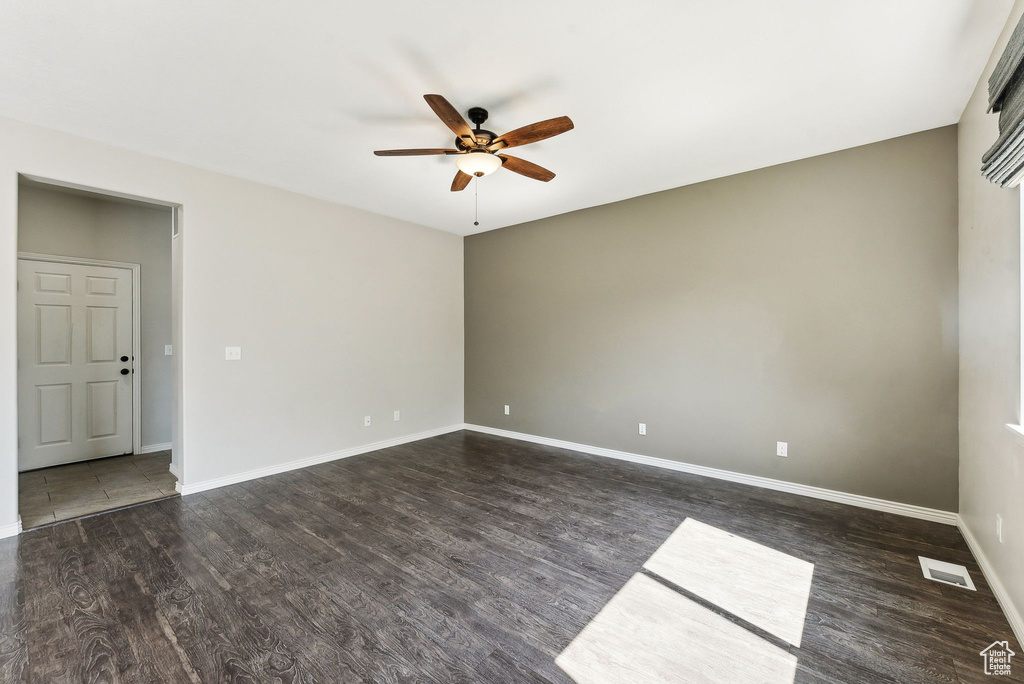 Unfurnished room with ceiling fan and hardwood / wood-style floors