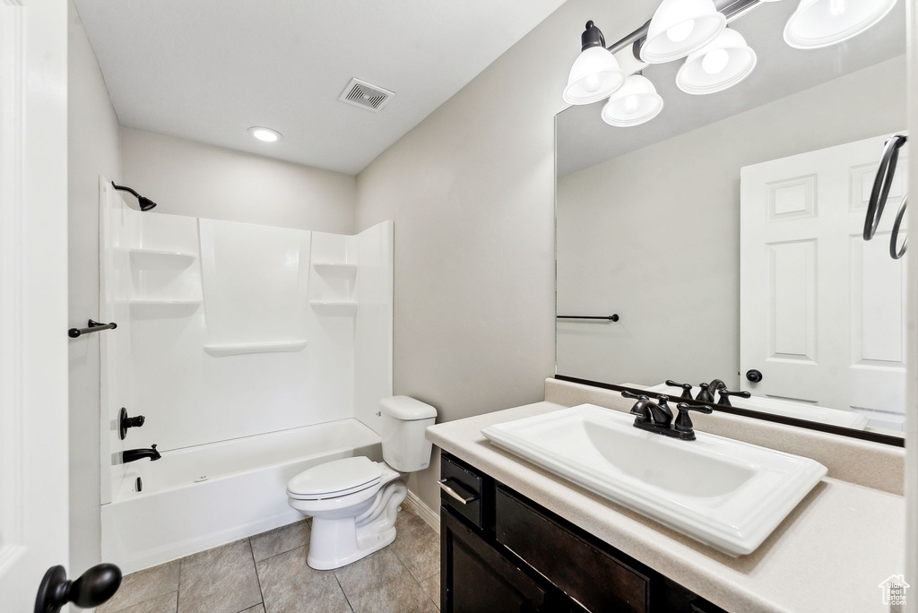 Full bathroom featuring tile patterned flooring, washtub / shower combination, toilet, and vanity