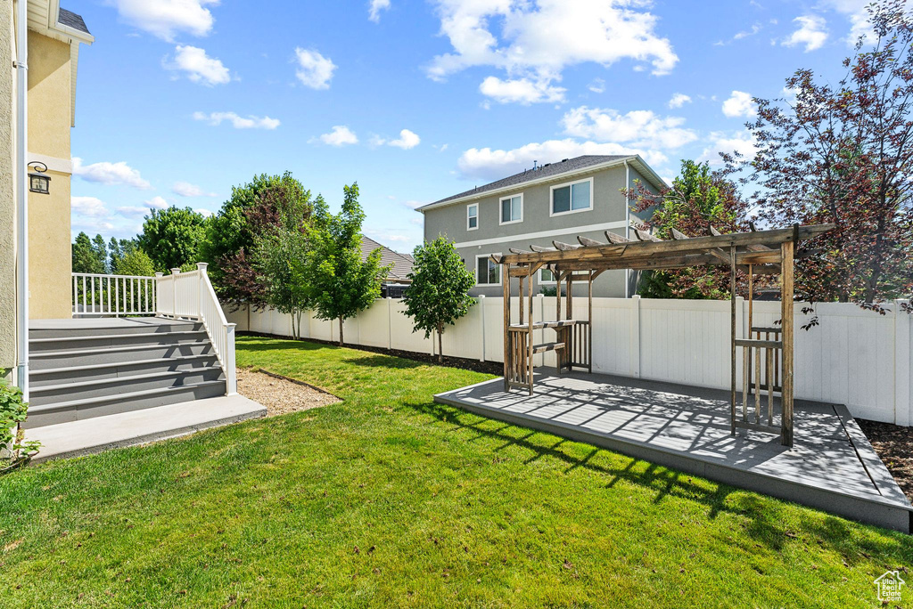 View of yard featuring a pergola and a deck